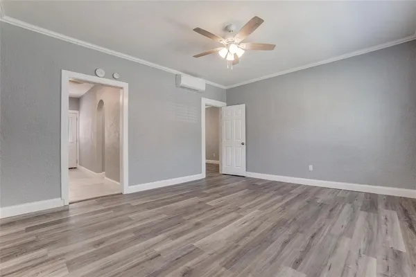 a view of an empty room with wooden floor