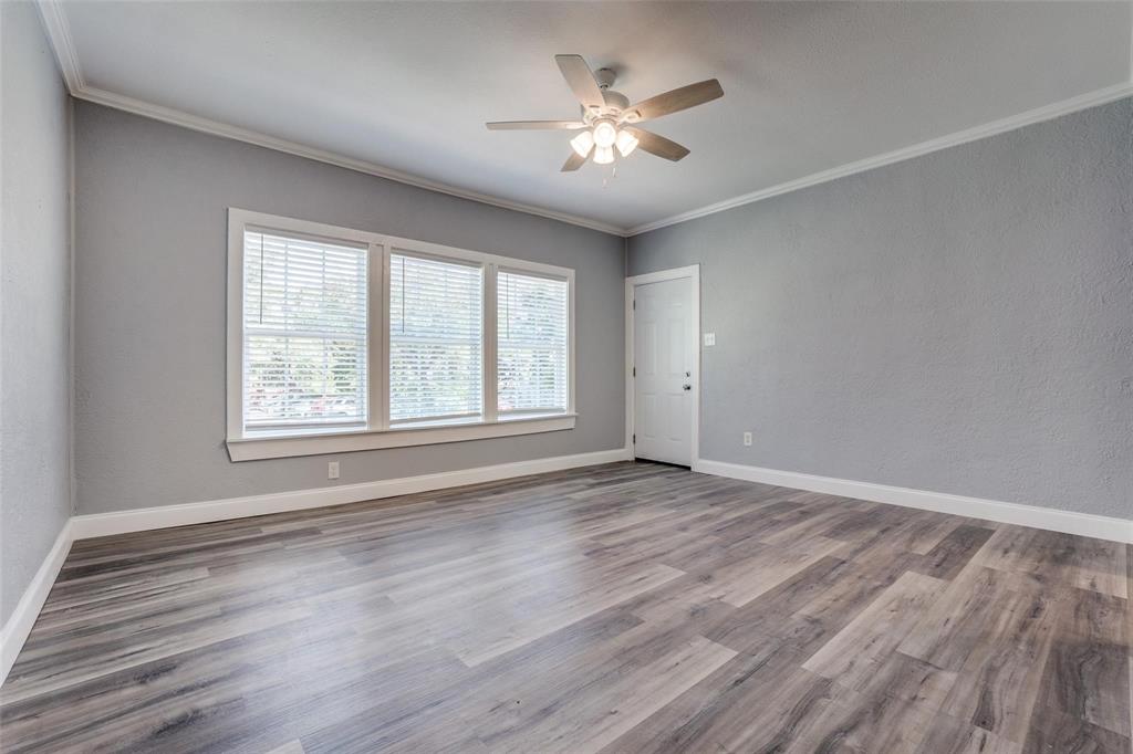 320 West Canty Street, Unit 2 Dallas, TX 75208 - Photo 4 of 11 a view of an empty room with a window and wooden floor