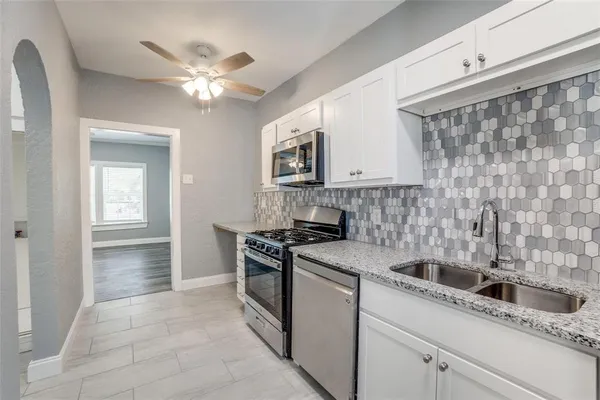 a kitchen with a sink stove and cabinets