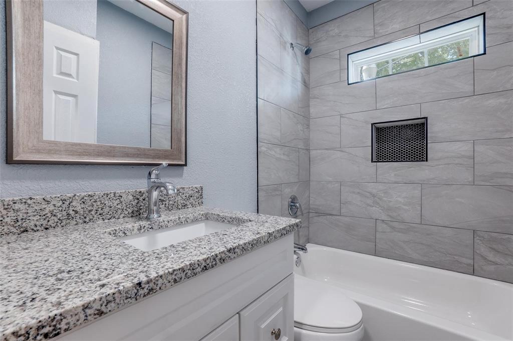 320 West Canty Street, Unit 2 Dallas, TX 75208 - Photo 9 of 11 a bathroom with a granite countertop sink toilet and bathtub