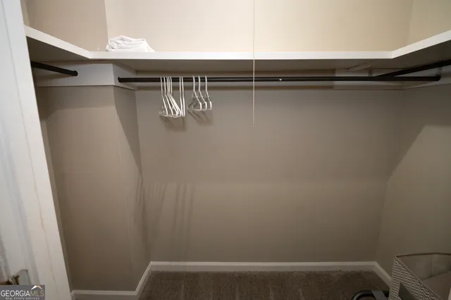 a bedroom with a bed and a mirror