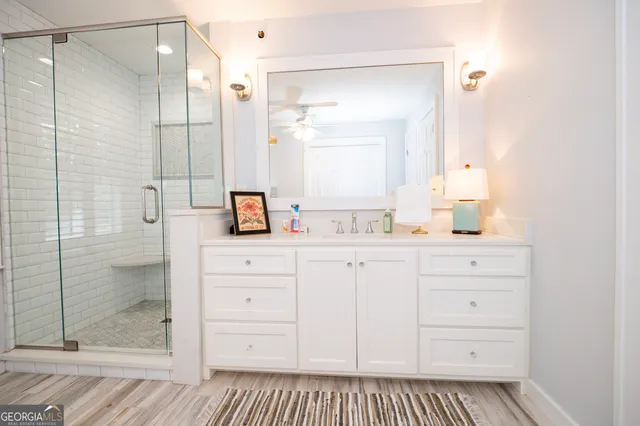 a view of a dining room with furniture a chandelier and wooden floor