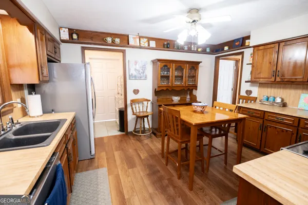 a kitchen with a table chairs stove and refrigerator