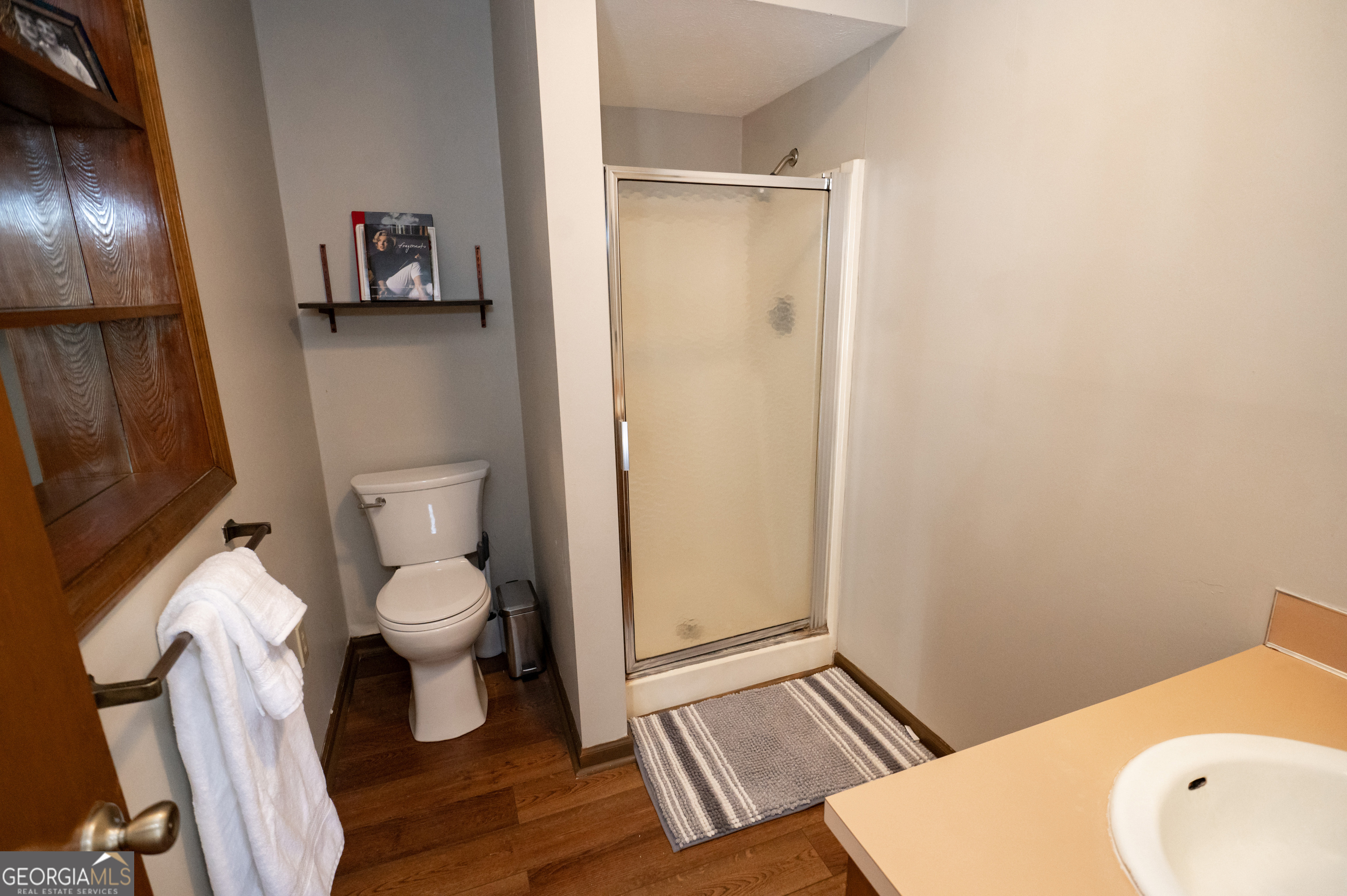371 Mountain Hill Road Fortson, GA 31808 - Photo 36 of 42 a white toilet sitting next to a bathroom sink and vanity