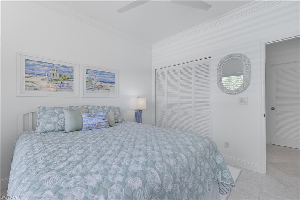 326 Bradstrom Circle, Unit 203F Naples, FL 34113 - Photo 12 of 24 a bedroom with a large bed and a window