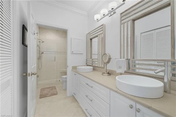 a bathroom with a double vanity sink mirror and shower