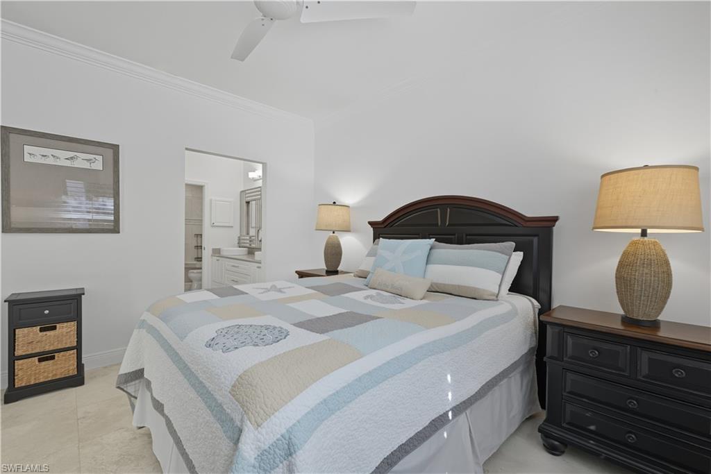 326 Bradstrom Circle, Unit 203F Naples, FL 34113 - Photo 16 of 24 a bedroom with a bed and a mirror