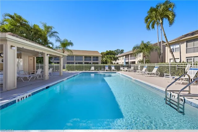 a swimming pool view with a outdoor seating