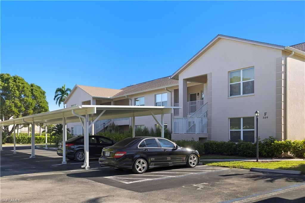326 Bradstrom Circle, Unit 203F Naples, FL 34113 - Photo 23 of 24 a car parked in front of a house