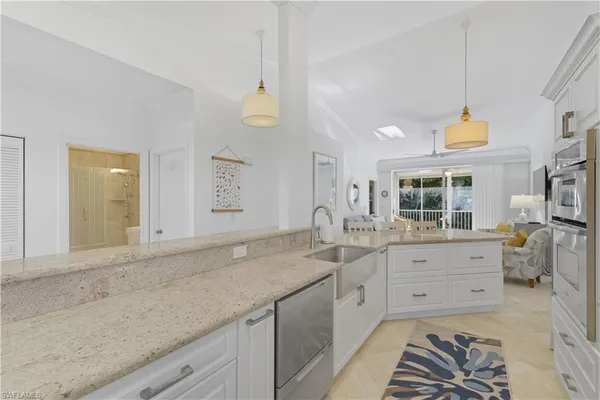 a spacious bathroom with a granite countertop sink and a mirror