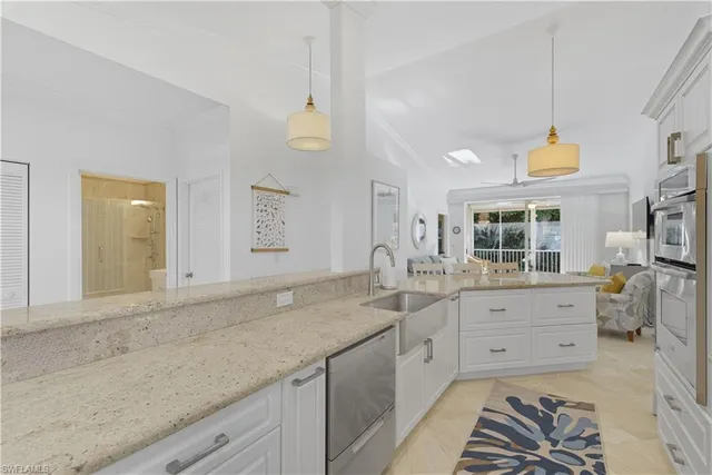 a spacious bathroom with a granite countertop sink and a mirror