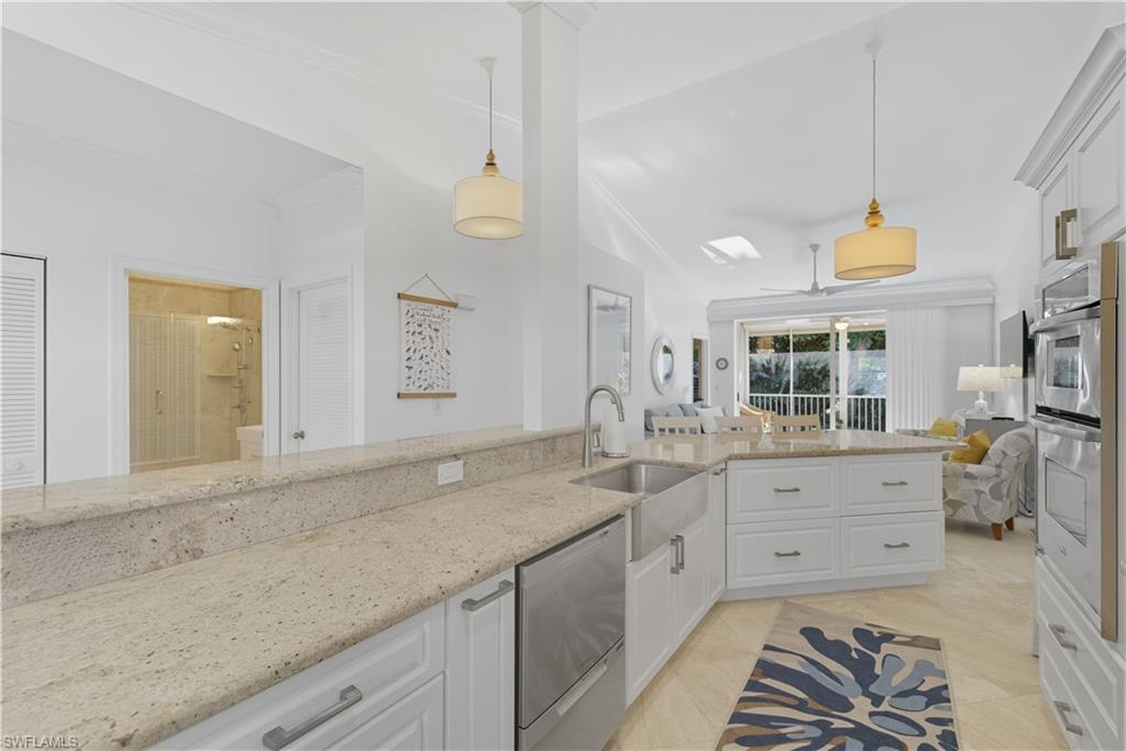 326 Bradstrom Circle, Unit 203F Naples, FL 34113 - Photo 4 of 24 a spacious bathroom with a granite countertop sink and a mirror