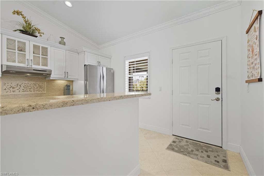326 Bradstrom Circle, Unit 203F Naples, FL 34113 - Photo 7 of 24 a view of livingroom with hardwood floor and hallway