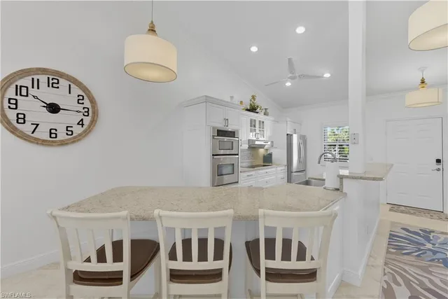 a view of kitchen with sink and refrigerator