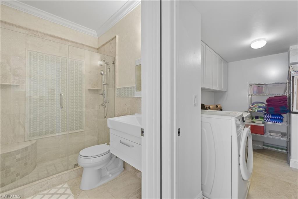 326 Bradstrom Circle, Unit 203F Naples, FL 34113 - Photo 10 of 24 a bathroom with a toilet sink and shower