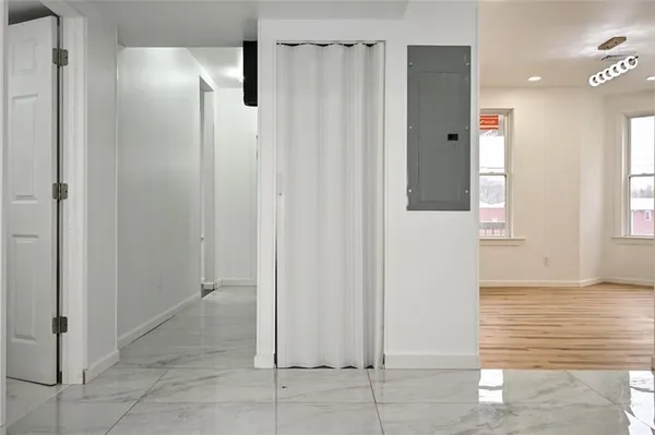 a view of a hallway with wooden shelves