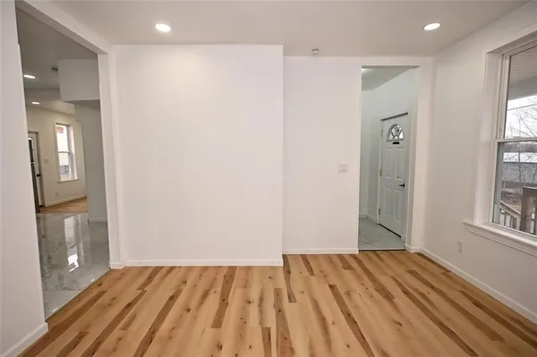 a view of a room with wooden floor and windows
