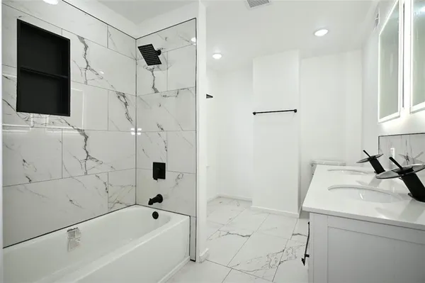 a bathroom with a bathtub and a shower