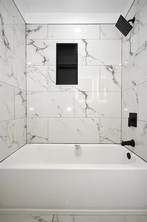 a bathroom with a bathtub and a shower