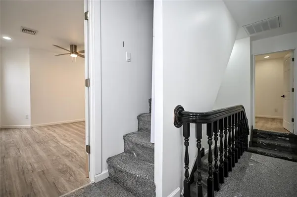 a view of hallway with wooden floor