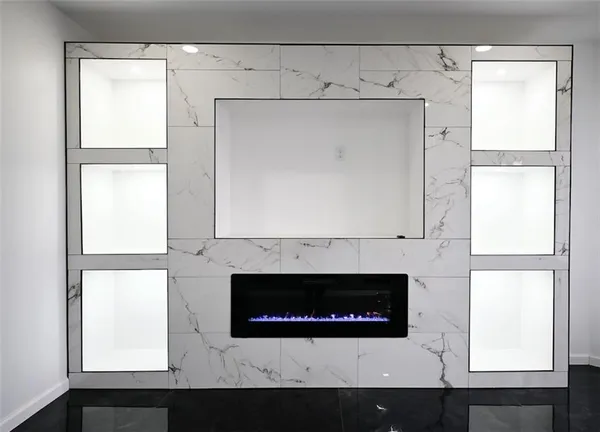 a living room with a fireplace and a large window