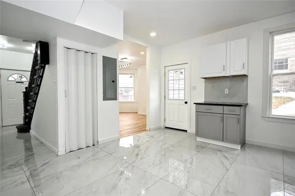 an empty room with windows and closet