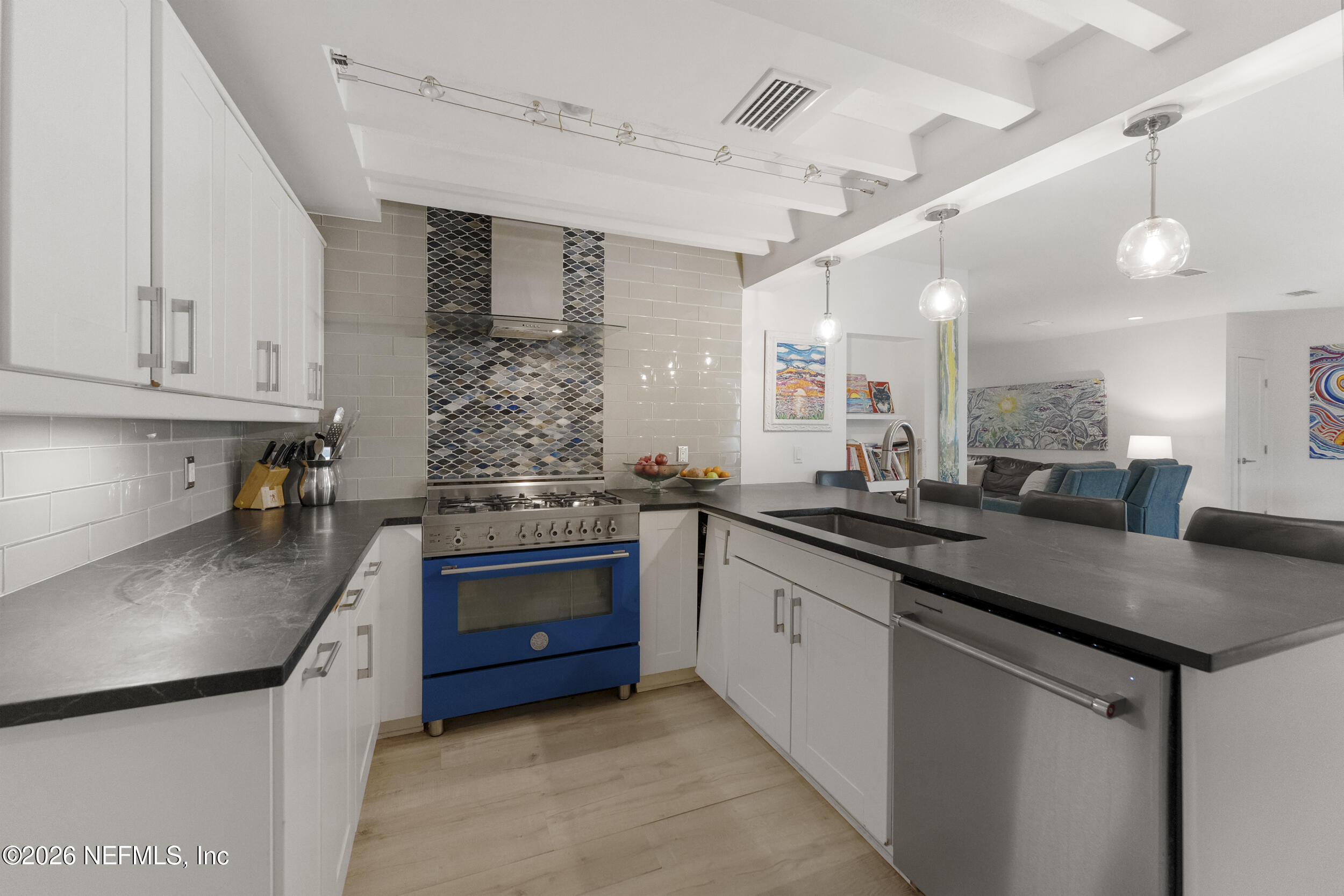 331 10th Street Atlantic Beach, FL 32233 - Photo 11 of 70 a kitchen with stainless steel appliances granite countertop a sink stove and cabinets