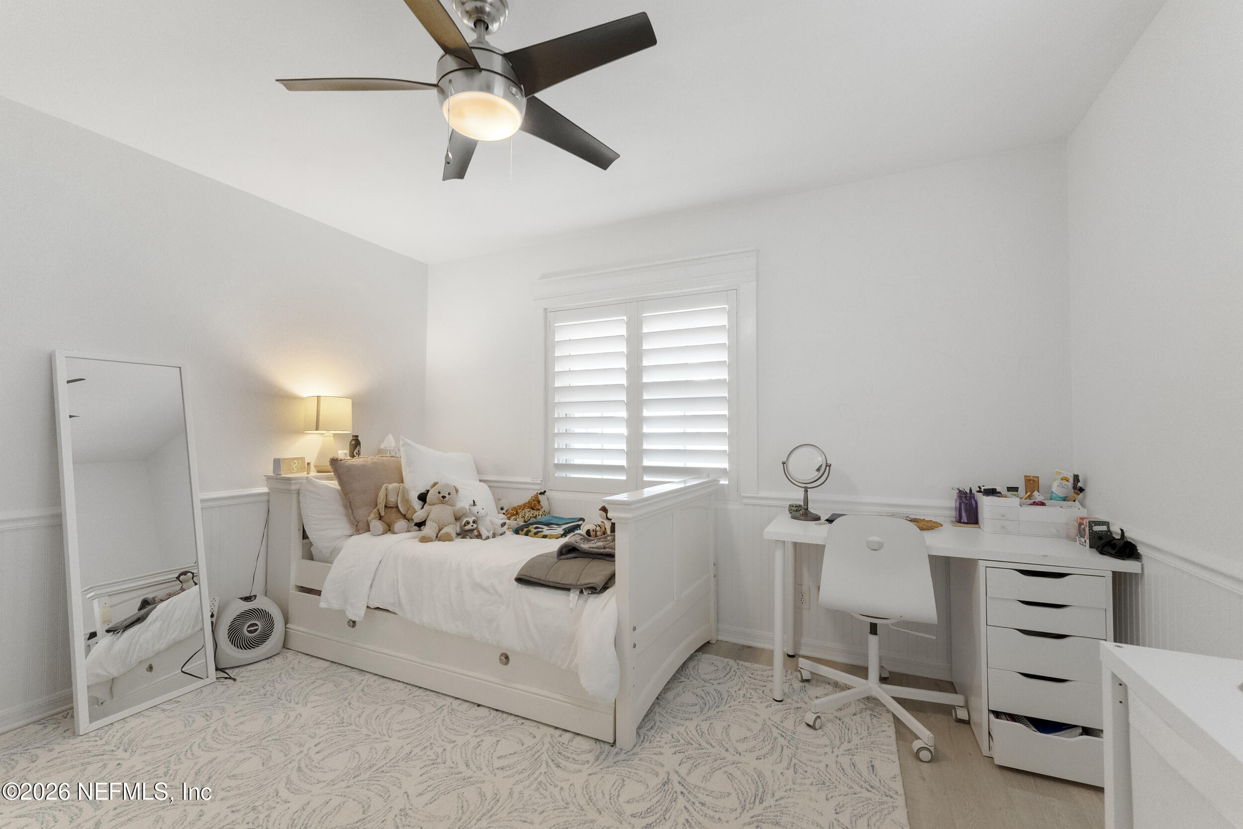 331 10th Street Atlantic Beach, FL 32233 - Photo 21 of 70 a bedroom with a bed and a chandelier