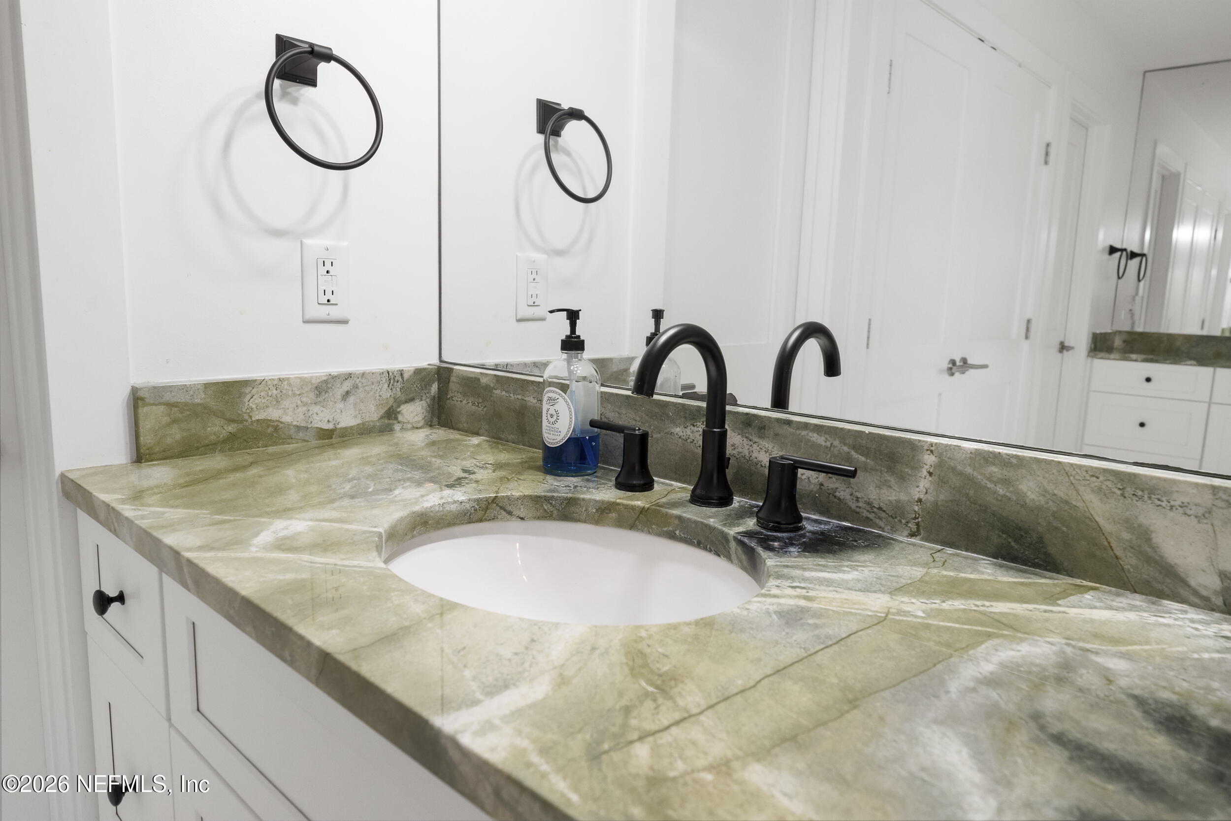 331 10th Street Atlantic Beach, FL 32233 - Photo 24 of 70 a bathroom with a sink and a mirror