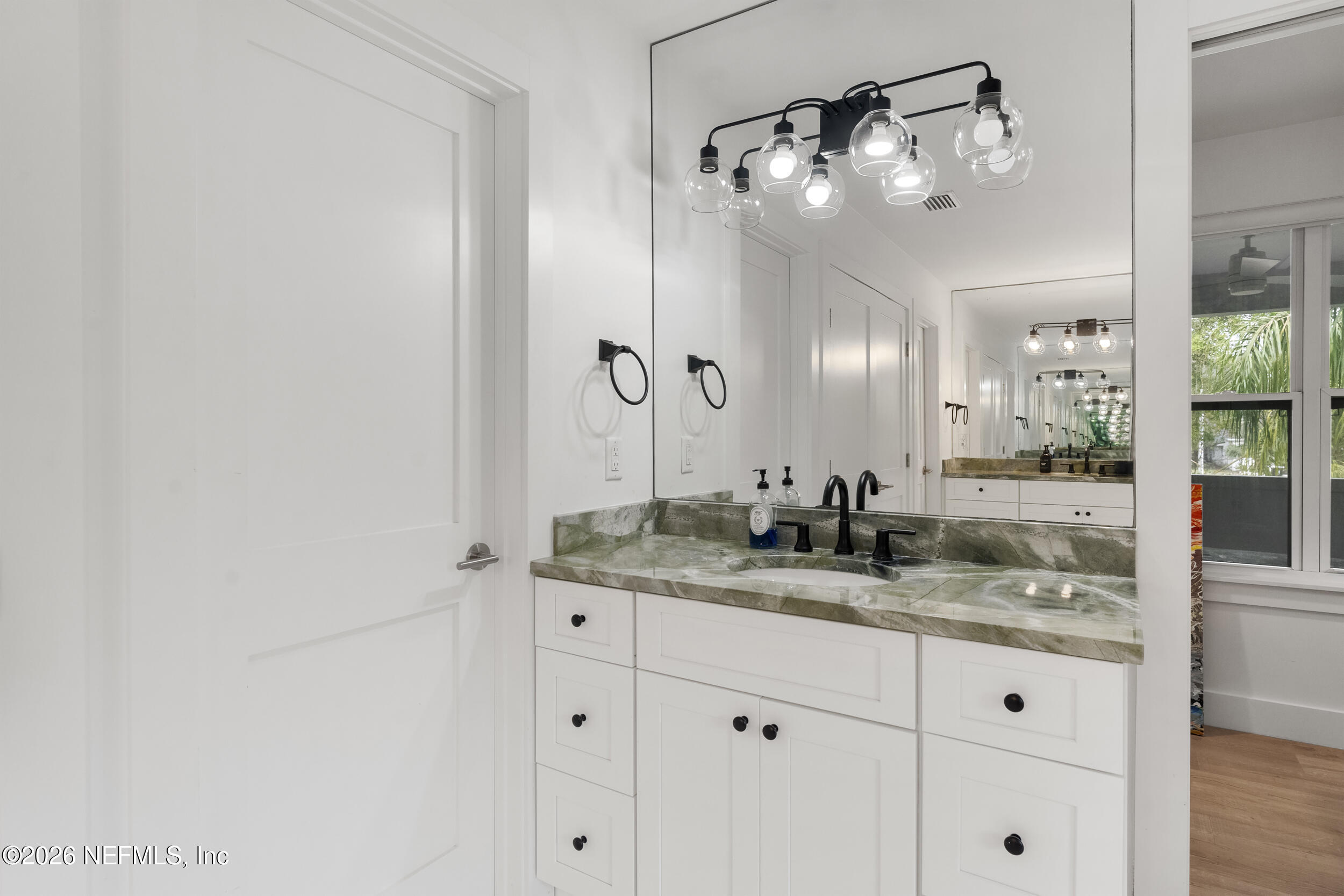 331 10th Street Atlantic Beach, FL 32233 - Photo 25 of 70 a bathroom with a granite countertop sink vanity and mirror