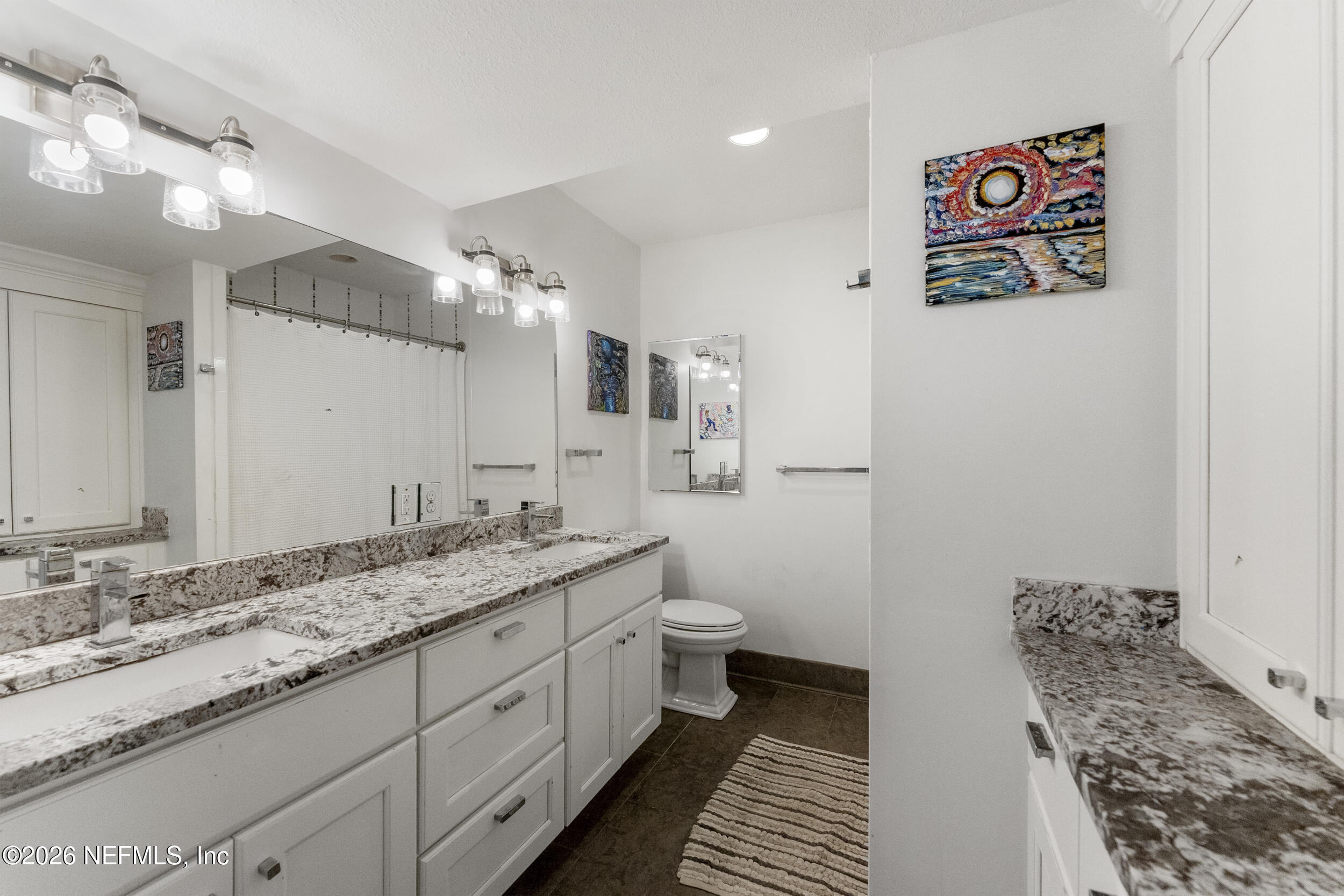 331 10th Street Atlantic Beach, FL 32233 - Photo 27 of 70 a spacious bathroom with a granite countertop sink and a mirror