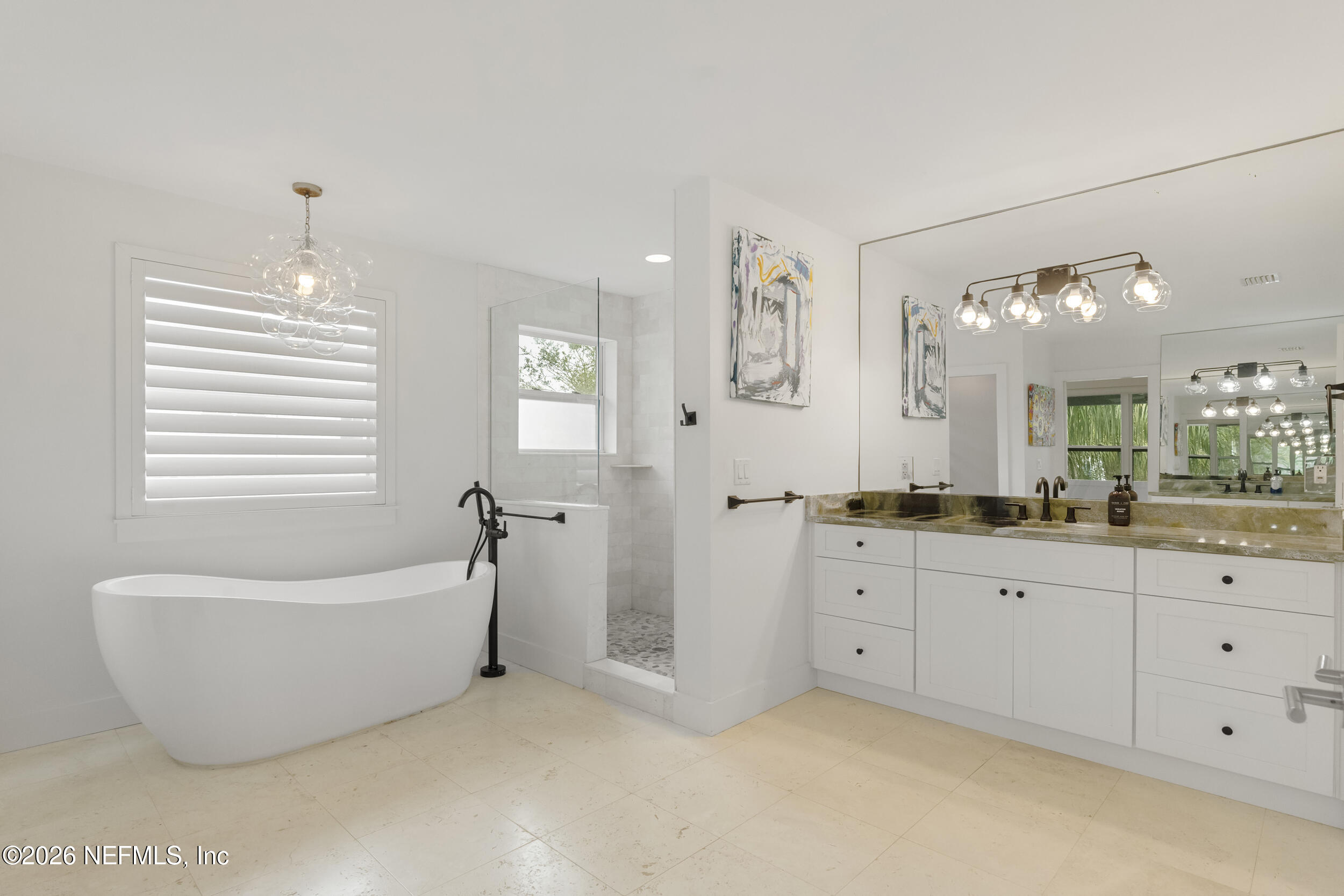 331 10th Street Atlantic Beach, FL 32233 - Photo 33 of 70 a spacious bathroom with a tub sink and mirror