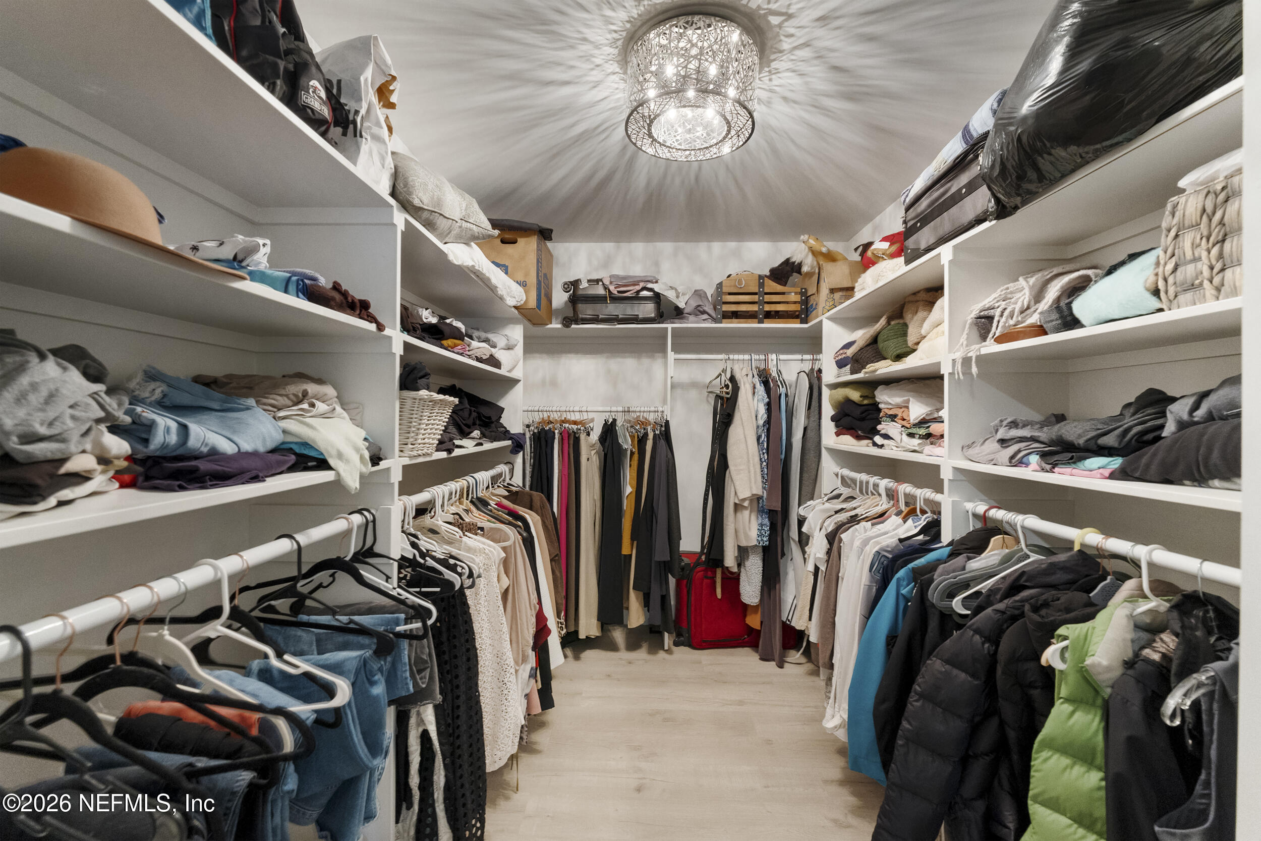 331 10th Street Atlantic Beach, FL 32233 - Photo 40 of 70 a view of walk in closet with clothes and shoes