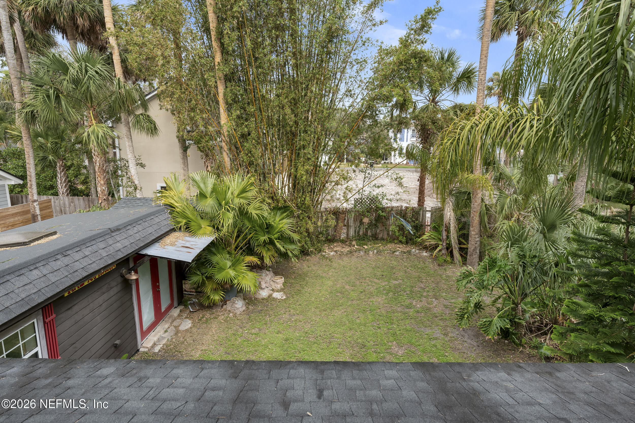 331 10th Street Atlantic Beach, FL 32233 - Photo 42 of 70 a backyard of a house with large trees and plants