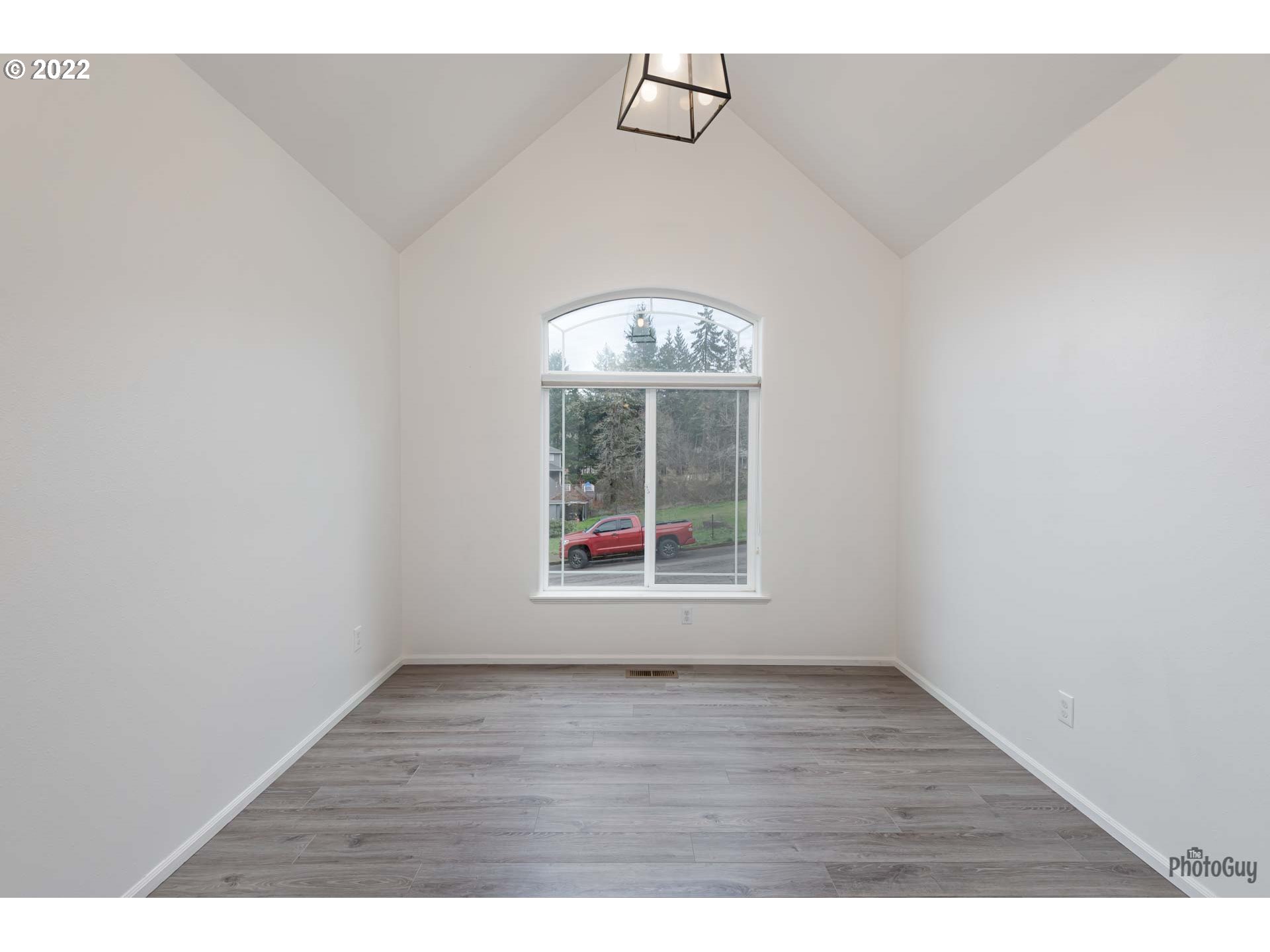 818 South 67th Street Springfield, OR 97478 - Photo 12 of 32 a view of an empty room with wooden floor and a window