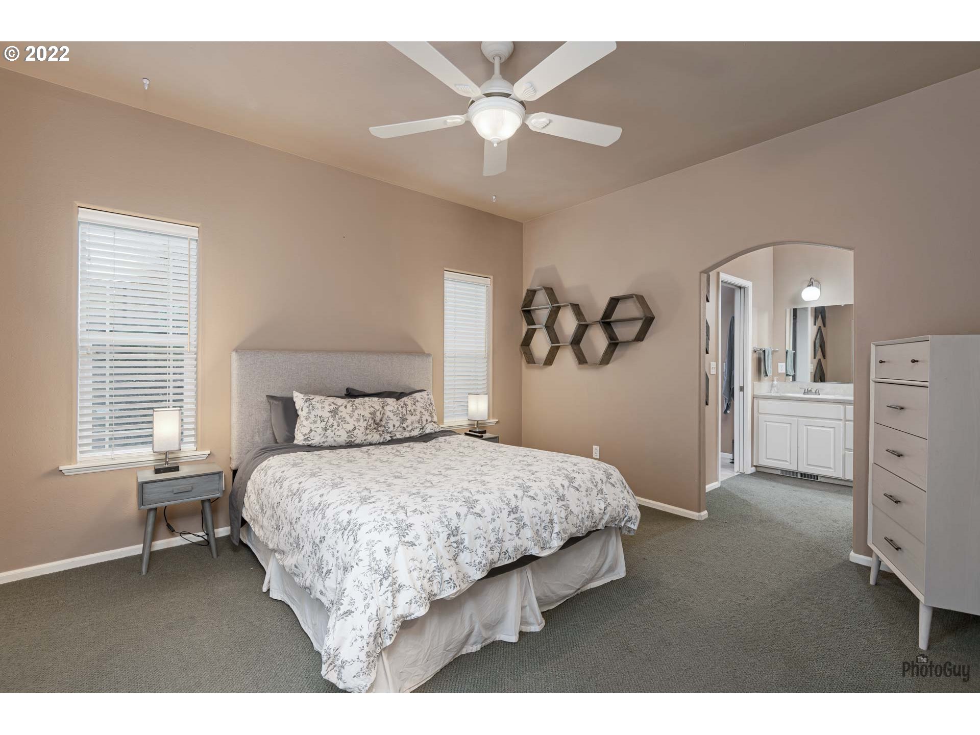 818 South 67th Street Springfield, OR 97478 - Photo 14 of 32 a bedroom with a large bed and a chandelier