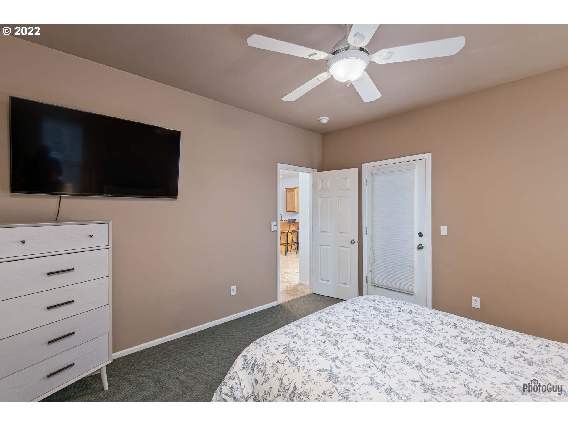 818 South 67th Street Springfield, OR 97478 - Photo 16 of 32 a bedroom with a bed and a flat screen tv