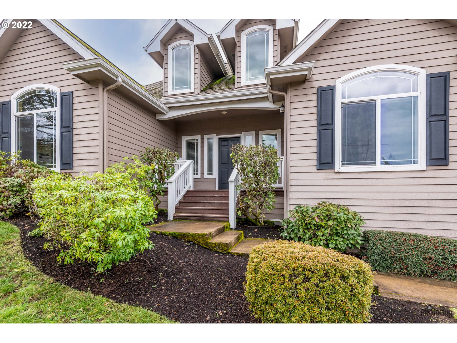 818 South 67th Street Springfield, OR 97478 - Photo 2 of 32 a view of a house with potted plants and a bench