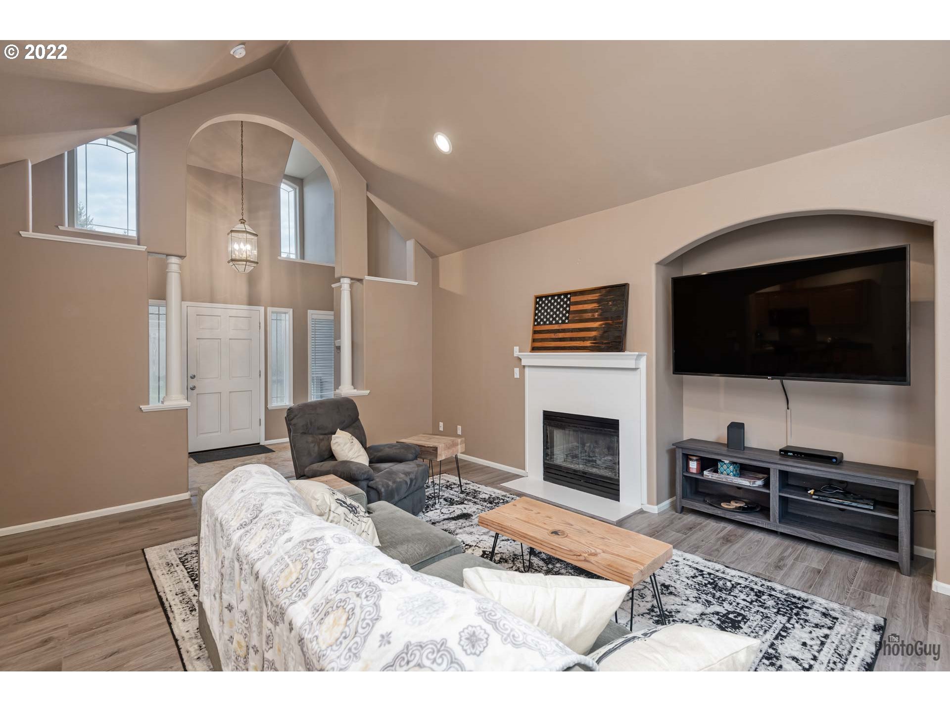 818 South 67th Street Springfield, OR 97478 - Photo 5 of 32 a living room with furniture a flat screen tv and a fireplace