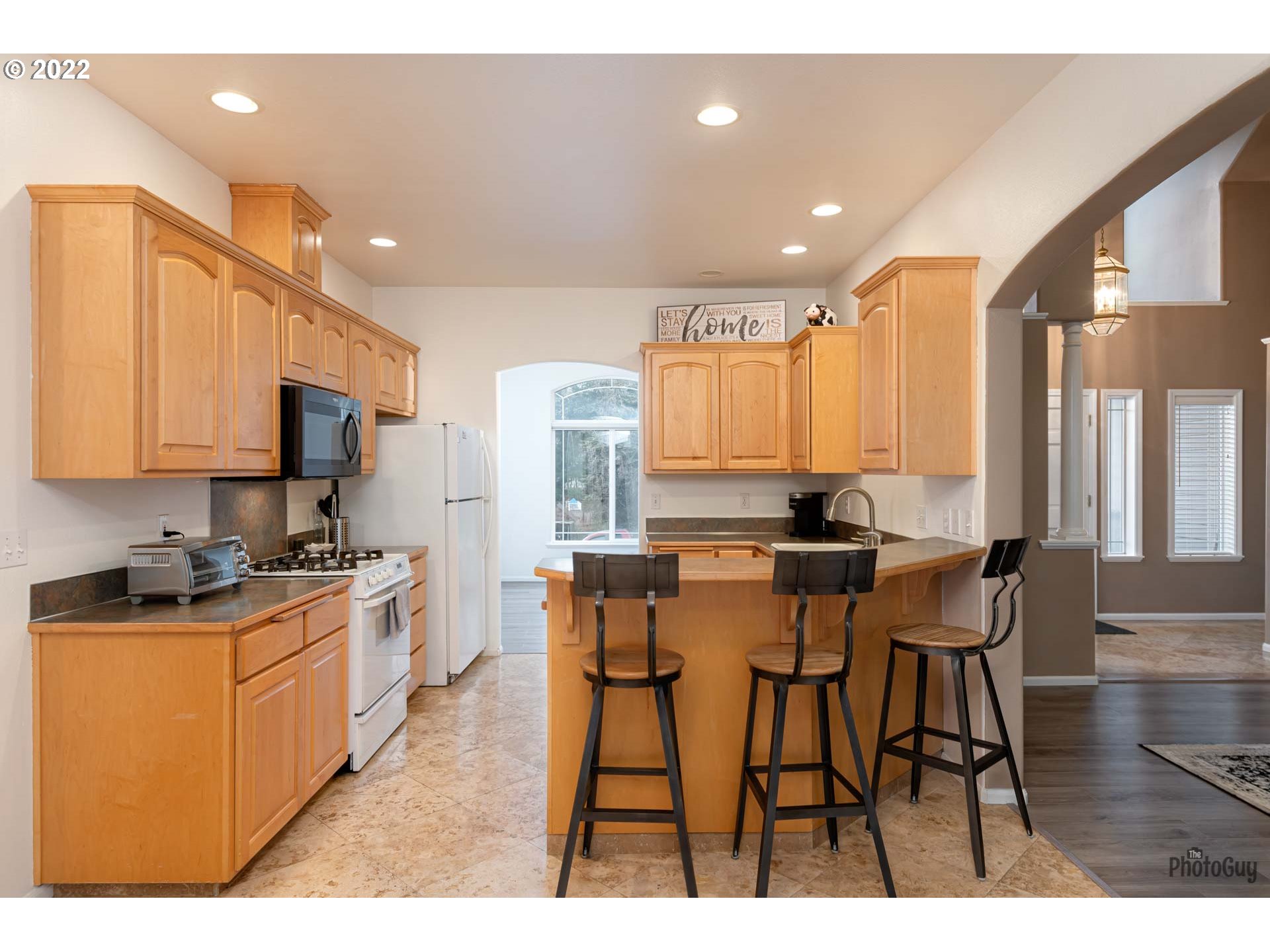 818 South 67th Street Springfield, OR 97478 - Photo 8 of 32 a kitchen with stainless steel appliances kitchen island granite countertop a stove top oven a sink a dining table and chairs