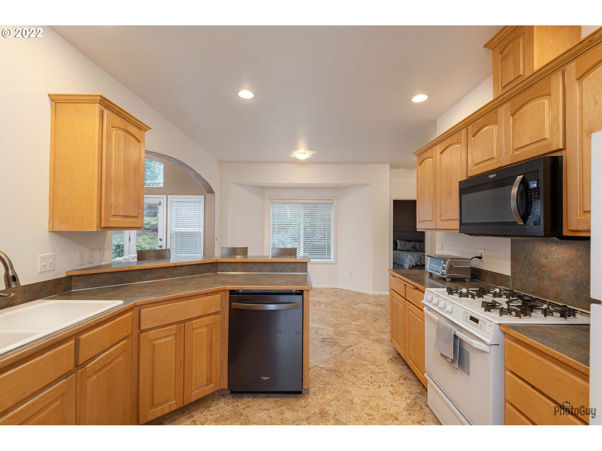 818 South 67th Street Springfield, OR 97478 - Photo 10 of 32 a kitchen with stainless steel appliances granite countertop a stove a sink and a microwave