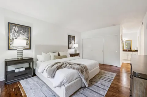 a bedroom with a bed and a lamp on table