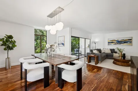 a view of a dining room with furniture window and wooden floor