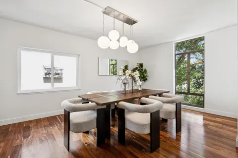 a dining room with furniture and wooden floor
