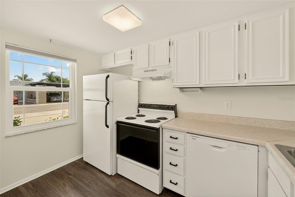 3422 Trophy Boulevard New Port Richey, FL 34655 - Photo 7 of 23 a kitchen with stainless steel appliances white cabinets and a refrigerator