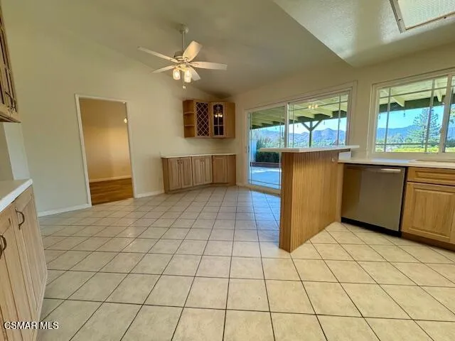 a kitchen with stainless steel appliances cabinets and window