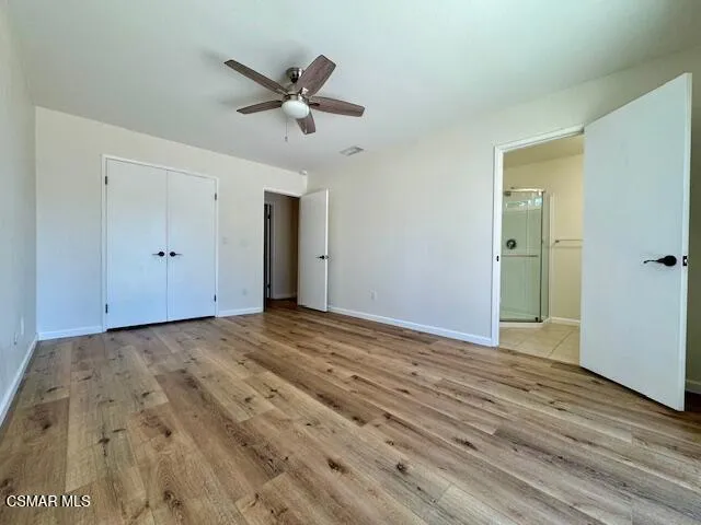 a view of a livingroom with a hardwood floor and a ceiling fan