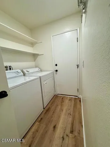 a room with a sink a washer and dryer