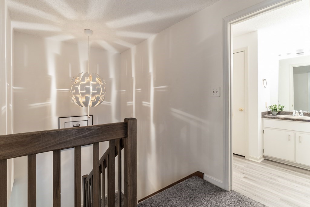46 Mountain Gate Road, Unit 46 Ashland, MA 01721 - Photo 5 of 14 a view of a hallway and a dining room with wooden floor