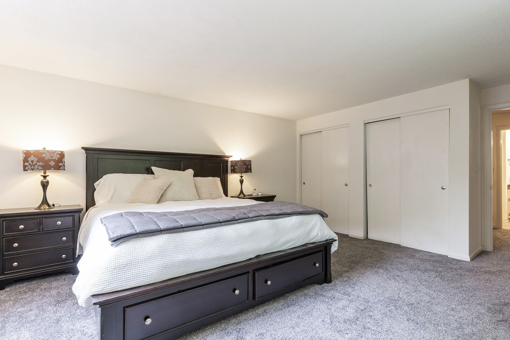 46 Mountain Gate Road, Unit 46 Ashland, MA 01721 - Photo 9 of 14 a bedroom with a bed and a night stand